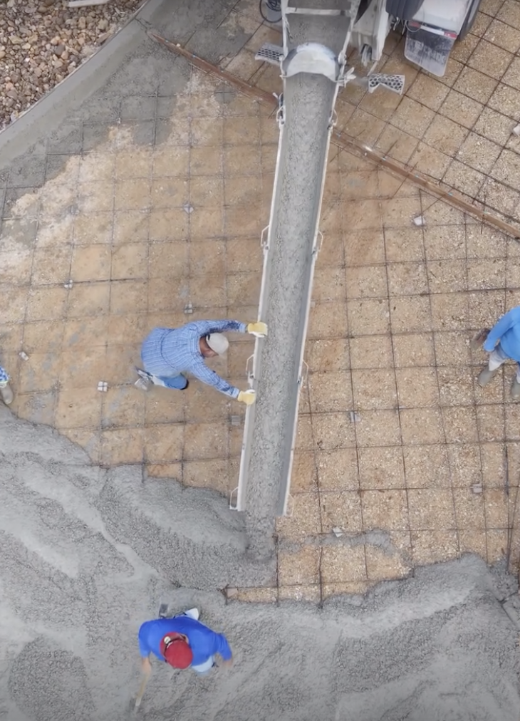 Overhead view of a crew placing concrete over reinforced forms