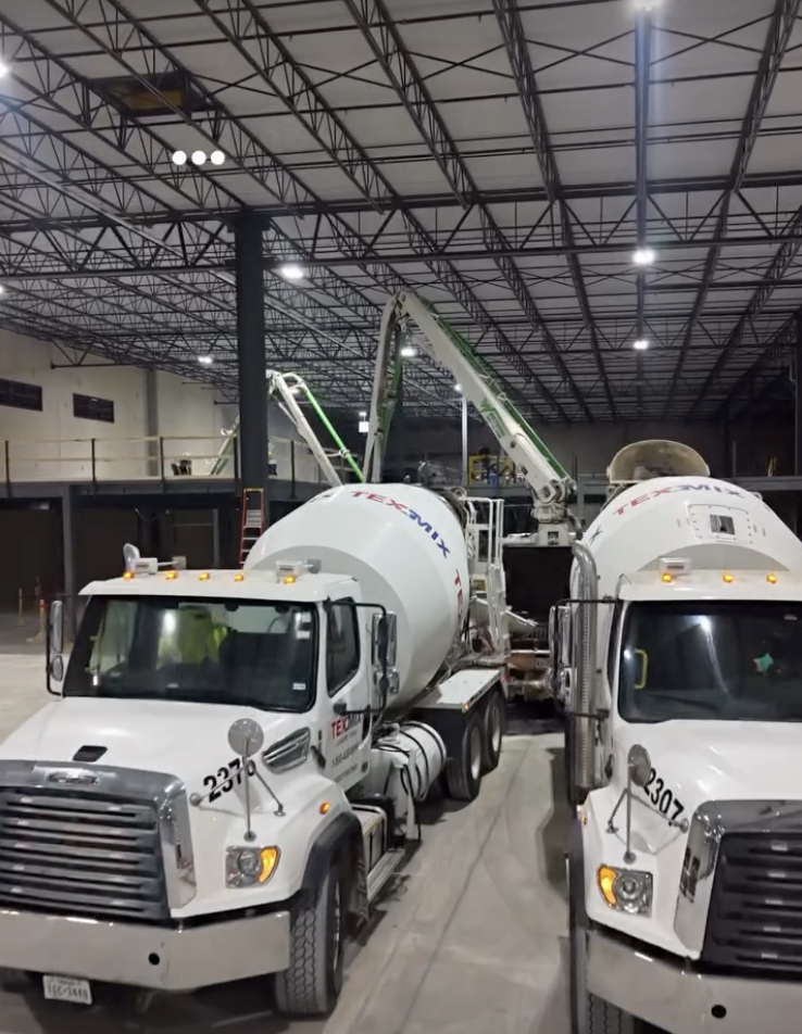 Concrete trucks working inside a large building